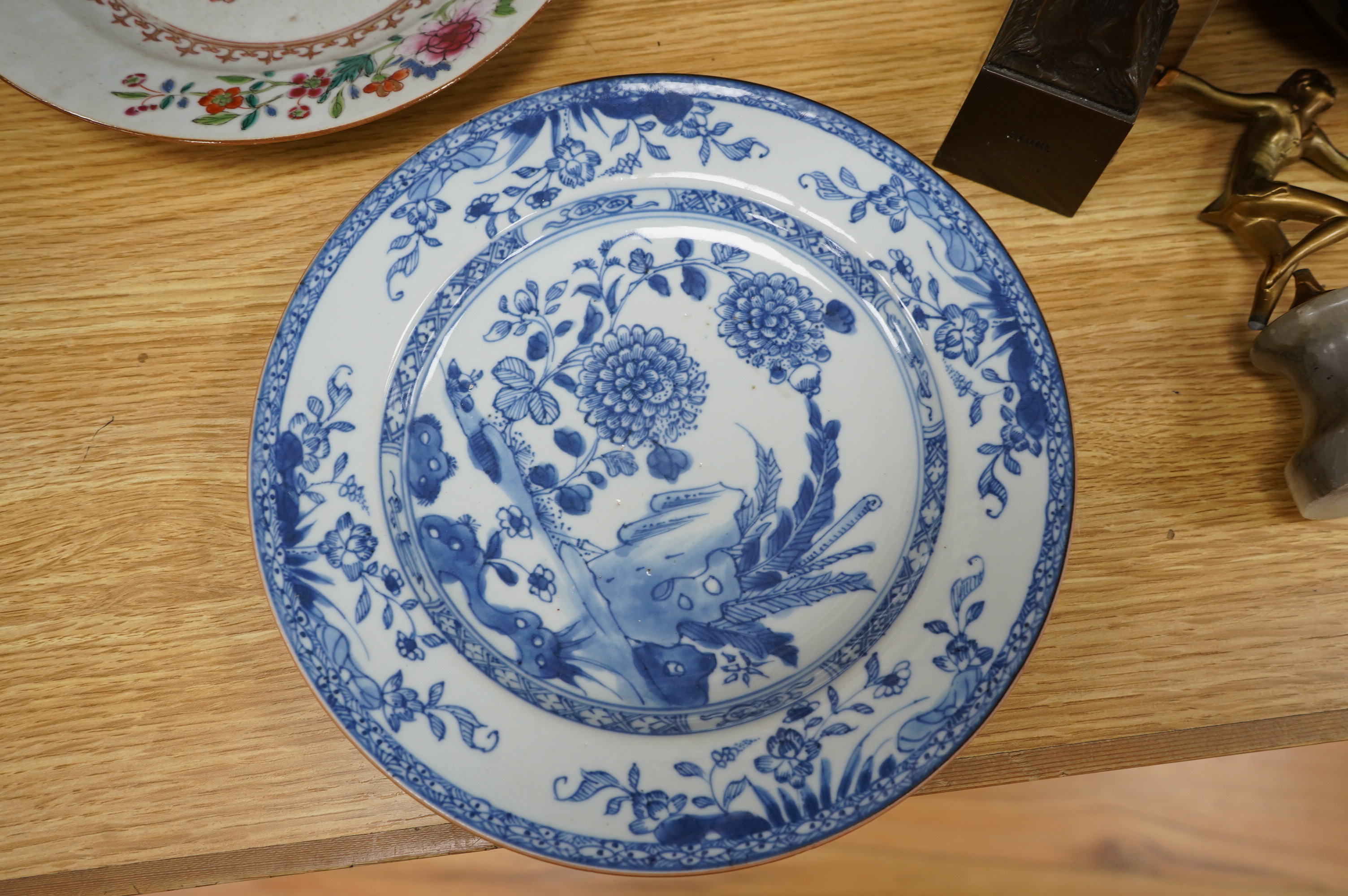 Two 18th century Chinese export plates, one blue and white the other famille rose, largest 23cm diameter. Condition - fair to good